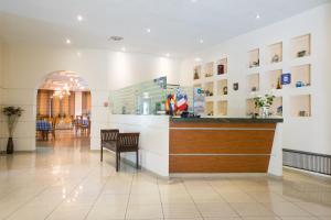 a lobby of a hospital with a counter and chairs at Nestorion Hotel in Athens