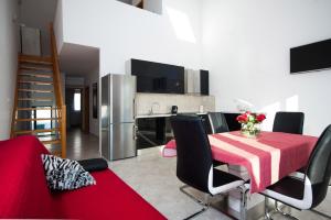 a kitchen and dining room with a red table and chairs at Apartment Milna in Milna