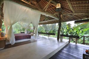 a bedroom with a canopy bed in a resort at Batukaru Coffee Estate in Tabanan