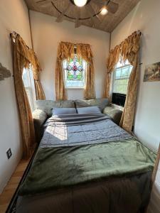 a bedroom with a bed and a window at Tiny House Farm Stay Pets Welcome in Battle Ground