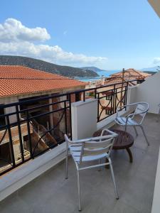 a balcony with chairs and a view of the ocean at NMD house in Ermioni