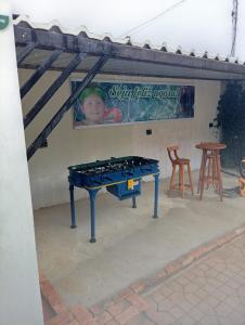 a ping pong table in a patio with a sign at Recanto da Serra Vazante in Vazante