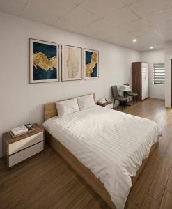 a bedroom with a large white bed and a desk at Eco Nest Hotel 6 Đình Ngang in Hanoi
