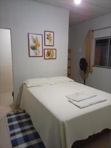 a bedroom with a white bed with towels on it at Recanto da Serra Vazante in Vazante +24 photos