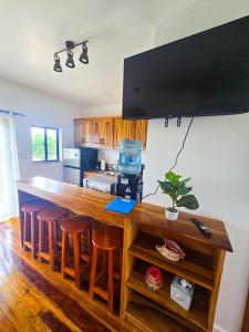 a kitchen with a counter with bar stools at Sand and Sol Rental in Hopkins +25 photos