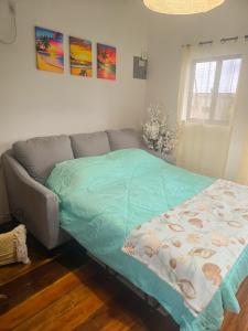 a bed in a living room with a couch at Sand and Sol Rental in Hopkins