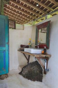 a bathroom with a sink and a mirror at Batukaru Coffee Estate in Tabanan