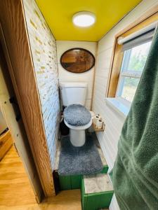 a small bathroom with a toilet in a tiny house at Tiny House Farm Stay Pets Welcome in Battle Ground