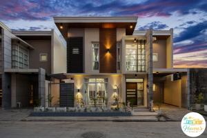 a large house with a sunset in the background at Haven's Villa in Agus