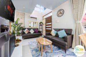 a living room with a couch and a table at Haven's Villa in Agus