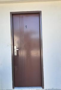 a brown door with the number one on it at JlRC Apartelle in Santa Catalina
