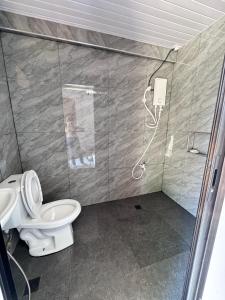 a bathroom with a shower and a toilet at JlRC Apartelle in Santa Catalina