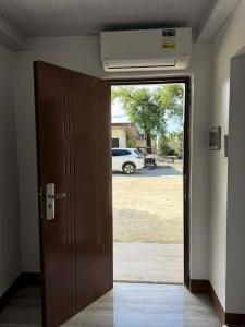 an open door with a car parked in a parking lot at JlRC Apartelle in Santa Catalina
