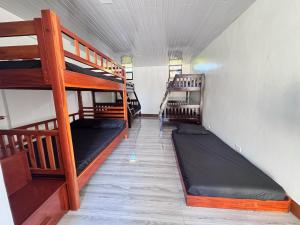 a room with three bunk beds in a room at JlRC Apartelle in Santa Catalina