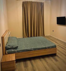 a bedroom with a bed with a green mattress at Billa Sea breeze in Baku