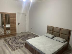 a bedroom with a bed and a large mirror at Billa Sea breeze in Baku