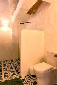 a bathroom with a white toilet in a room at Romantic Colonial Charm Barichara w Jacuzzi in Barichara