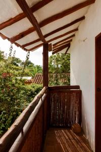 a porch of a house with a wooden railing at Romantic Colonial Charm Barichara w Jacuzzi in Barichara +19 photos