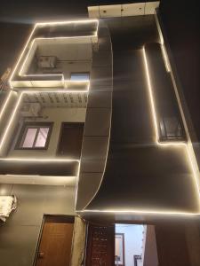 a ceiling in a building with lights on it at Sunrise stay in Mathura