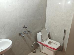 a bathroom with a toilet and a sink at Sunrise stay in Mathura