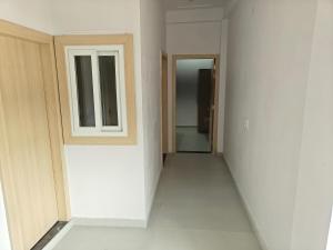 an empty hallway with a door and a window at Sunrise stay in Mathura