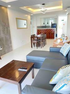 a living room with a blue couch and a table at OcamOcam Sunset-Bay Guest House in Busuanga