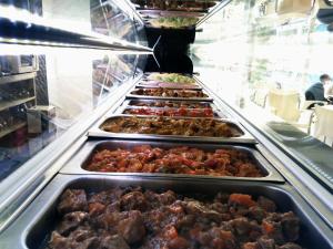 a row of trays of food in a buffet at Hostal El Altet in El Alted