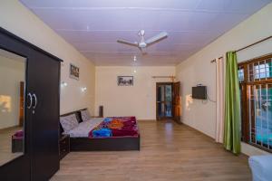 a bedroom with a bed and a ceiling at Forest Rest House Satobari in Dharamshala +79 photos