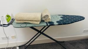a table with a surfboard on top of it at Celtic City Stay in Glasgow