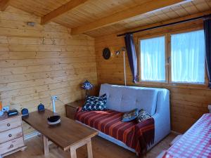 a living room with a couch and a table at Chalet Glamping in Myza Igaste