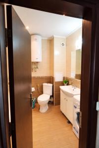 a bathroom with a toilet and a sink at Pomorie Sea&History Residence in Pomorie
