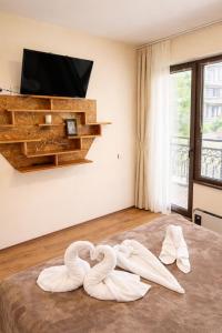 two swans are sitting on the floor in a room at Pomorie Sea&History Residence in Pomorie