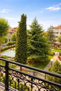 a view from a balcony of two large trees at Pomorie Sea&History Residence in Pomorie