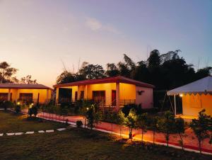 a house with a fence in front of it at Bandhav Moonlight Resort in Tāla