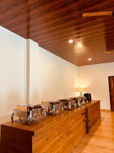 a row of drums in a room with a wooden ceiling at Bandhav Moonlight Resort in Tāla +17 photos