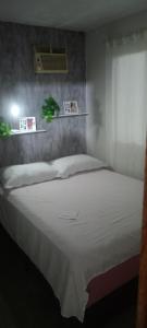 a bedroom with a large bed with a white blanket at Cabana do paraíso in Maragogi