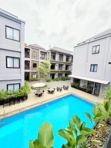 an image of an apartment complex with a swimming pool at M-LIVIN Hotel in Pangkal Pinang