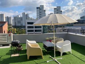 a patio with a table and chairs and an umbrella at Dontan terrace in Hwaseong