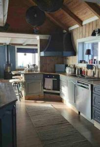 a kitchen with blue cabinets and a stove top oven at Renovated Mountain Cabin With Mountain Views in Al