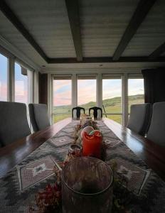 a table with a red candle on top of it at Renovated Mountain Cabin With Mountain Views in Al