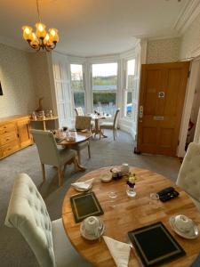 a living room with a wooden table and chairs at Rockhill Guest House in Moffat