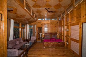 a living room with a couch and a table at Forest Rest House Satobari in Dharamshala