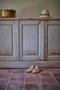 a pair of shoes on the floor in front of a cabinet at A Historic Gem With Wellness Comfort in Übersee