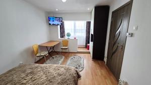 a bedroom with a bed and a table and a desk at Casa MARI-SOR in Vulcan +23 photos