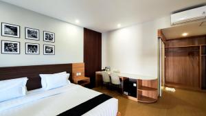 a hotel room with a bed and a desk at Nio Garden Hotel in Sumbawa Besar +59 photos