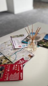 a table with a map and a jar of sticks at Celtic City Stay in Glasgow
