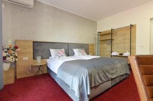 a bedroom with a large bed and a chair at Villa Rosa in Timişoara +33 photos