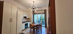 a kitchen with a table and a dining room at Viale Umberto Apartments in Sassari