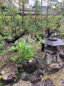 a garden with a stone table and some plants at Private Inn Ray in Nara