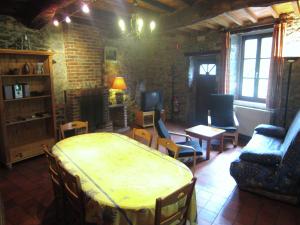 a living room with a bed and chairs and a couch at Riverside Retreat Viroinval in Treignes